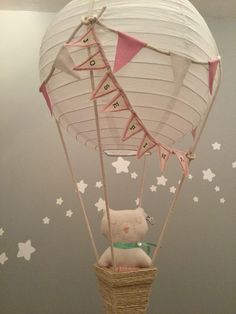 a teddy bear in a hot air balloon