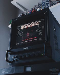 an old video game sitting on top of a black box with the title metal gear printed on it