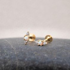 Our opal flat back earrings are dainty and completely waterproof! The 18G flat back design ensures comfort fit, making them ideal for everyday wear as well as special events. - Material: Genuine opal, High quality 925 sterling silver core material, 18 K gold filled, hypoallergenic - Size: Thickness - 18 G/ Height - 8mm  - Qty: sold as 1 piece - Turnaround time: Same day or Next day delivery guaranteed - Packed in gift jewelry box - Please ask me any questions ! I am quick to reply :) Thank you for visiting my shop - For shop policies, please visit: https://www.etsy.com/shop/DoodleJewelrybyDKArt White Dainty Cartilage Earrings For Gift, Dainty White Cartilage Earrings For Gift, Dainty White Cartilage Earrings As Gift, Dainty White Piercings As Gift, Flatback Earrings, Conch Stud, Tragus Conch, Conch Earring, Flat Back Earrings