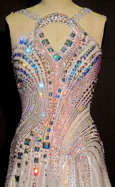 a white dress with lots of multicolored jewels on it