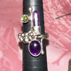 Stunning Excellently Crafted Artistic Sterling Silver Multi Gemstone Ring. A Work Of Art Carefully Executed With Rich Aesthetic Detailing. This Ring Features A Unique Coil Wrap Triple Shank Organically Designed To Rest At The Top Of The Ring With Beaded Ends. A Large Cabochon Of Deep Purple Amethyst Decorates One Side Of The Top With A Bezel Of Icicle Amethyst On The Other End. A Smaller Cab Of Peridot Is Set On The Left End That Formed The Shank. Is In Great Preloved Condition.. Please Feel Fre Rich Aesthetic, Multi Gemstone Ring, Judy Garland, Cabochon Ring, Peridot Gemstone, Crystal Rings, Purple Amethyst, Womens Jewelry Rings, Gemstone Ring