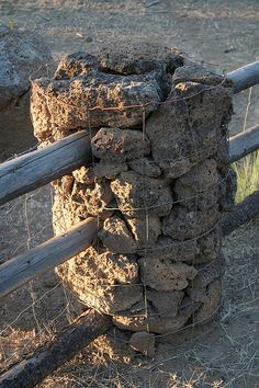 there is a fence that has some rocks on it