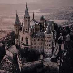 an aerial view of a castle in the mountains