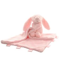 a pink stuffed bunny sitting on top of a blanket with its eyes closed and ears open