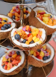 there are many fruits in the coconuts on this platter and it is ready to be eaten