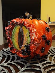 an eyeball decorated with spider webs and fake eyes sits on top of a table