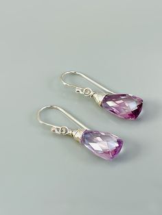 Lovely light amethyst e briolettes are nested into sterling silver settings and hang from sterling silver. Stones are approx. 8x 15mm Also available in 14k gold fill or rose gold fill. I lovingly handcraft all jewelry and hair accessories one at a time in my northern Michigan studio. Gemstones are nature's creations and may vary slightly in color and inclusions, but all are lovely and hand selected to match. **Orders come presented in a lovely box ready for gifting and US orders over $35 ship fr Faceted Briolette Teardrop Earrings, Sterling Silver Briolette Teardrop Gemstone Earrings, Sterling Silver Long Drop Teardrop Gemstone Earrings, Pink Sterling Silver Briolette Earrings, Pink Briolette Sterling Silver Earrings, Handmade Amethyst Teardrop Earrings, Purple Sterling Silver Teardrop Earrings, Purple Sterling Silver Teardrop Dangle Earrings, Lavender Teardrop Jewelry With Ear Wire