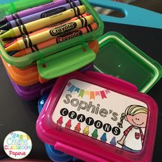 some crayons are sitting on a table and there is a sign that says sophiie's growing