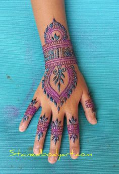 a person's hand with henna tattoos on it