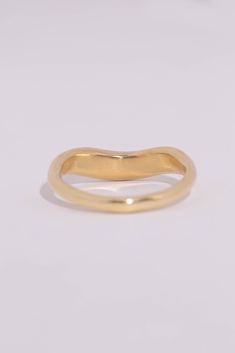 The Arc is a hand carved ring with a thick curve. Perfect for stacking or wearing on it's own. At the thickest part of the curve, the ring measures 4mm, and tapers in the back to 2mm. The thickness of the ring ranges from 1.8-2.5mm. Leave note at checkout indicating your ring size. Quarter and half sizes available. Made in Los Angeles with recycled 14k or 18k gold. Your choice of yellow, rose, or white. Hand engraving available on the inside of the band (up to 10 characters). Made to order, plea Classic Curved 14k Gold Rings, Untreated Round Band Ring For Anniversary, Curved 14k Gold Rings For Anniversary, 14k Gold Curved Rings For Anniversary, 14k Gold Curved Anniversary Rings, Gold Curved Rings With Polished Finish, Classic Curved Gold Rings, Minimalist Curved Yellow Gold Ring, Curved Yellow Gold Rings With Polished Finish