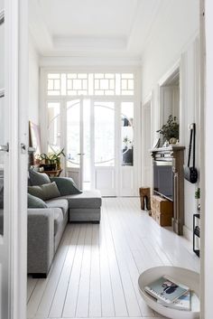 a living room filled with furniture and white walls