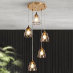 three lights hanging from a ceiling in a room