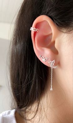 a woman wearing a pair of ear piercings