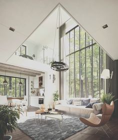 a living room filled with furniture and large windows