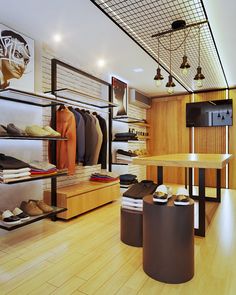 the inside of a clothing store with wooden floors