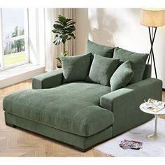 a living room with a large green couch