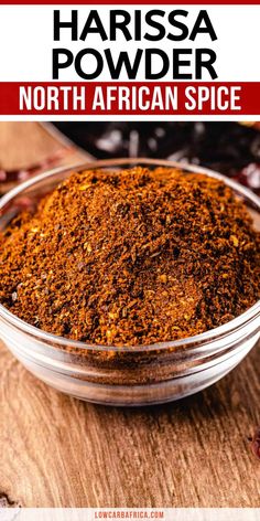 a bowl filled with spices on top of a wooden table