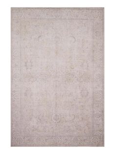 an antique rug with white and beige colors on the ground, in front of a white background