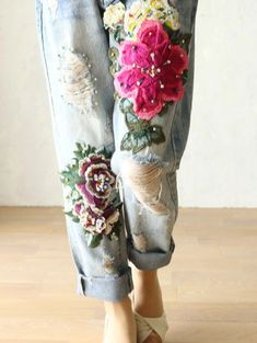 a woman's jeans with flowers on them