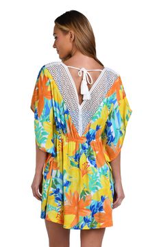 This bright and cheerful floral print has a summery vibe, perfect for a beach day. Styled with breezy dolman sleeves and a flowy fit, this cover-up is finished with crochet trim, braided ties, and thread tassels for a playful touch. [split] Details V-neck caftan Ties at neck Dolman sleeves Braided ties with thread tassels Breezy silhouette Fabric 100% Rayon Crepe V-neck Beach Dress With Lace Trim, V-neck Beach Dress With Lace Trim As Cover-up, Spring Beach Party Cover-up With Crochet Trim, Bohemian V-neck Swimwear For Spring, Multicolor V-neck Cover-up For Beach Party, Beachy Multicolor V-neck Cover-up, Floral Print V-neck Cover-up For Vacation, Multicolor V-neck Beach Dress With Floral Print, Spring V-neck Pool Cover-up