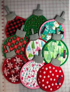 several christmas ornaments are laid out on a cutting board and ready to be sewn