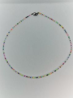 Subdued multi-colored beaded necklace. Trendy Multicolor Faceted Bead Necklaces, Trendy Multicolor Handmade Beaded Necklaces, Trendy Handmade Multicolor Beaded Necklaces, Trendy Colorful Beads For Jewelry Making, Colorful Beaded Necklaces With Tiny Round Beads, Multicolor Round Beads Necklace For Summer, Trendy Multicolor Beaded Necklaces With Large Beads, Trendy Multicolor Beaded Necklace With Large Beads, Trendy Multicolor Necklaces With Faceted Beads