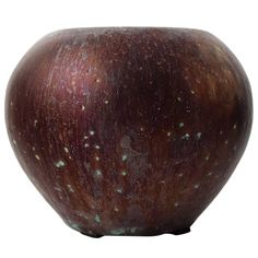 a brown vase with green speckles on it's sides and bottom half