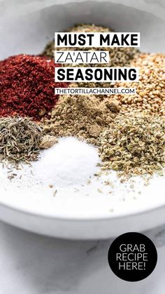 a bowl filled with different types of seasoning on top of a white countertop