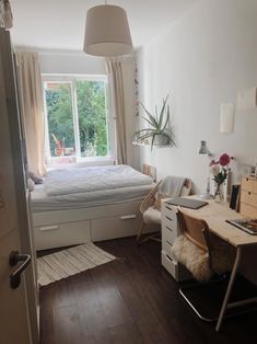 a bedroom with a bed and desk in it