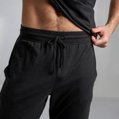 Your leisurely weekend pants (your favorite genre). Buttery soft and perfectly weighted, this kind-to-the-earth blend is made from organic cotton and natural fibers. Featuring ribbed elastic waistband with adjustable drawstring, functional pockets, and a flattering tapered leg. Go from lazy in bed, to morning coffee walk. No outfit change required. Lazy In Bed, Coffee Walk, Man Fashion, Sleep Set, Hand Chain, Short Leggings, Dress With Cardigan, Dress Romper, Body Size