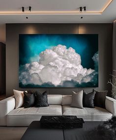 a living room filled with furniture and a large painting on the wall above it's couch