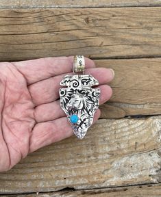 Beautiful large arrowhead.. 3 1/4" tall with the bail by 1 9/16" wide at the widest spot handmade in sterling silver with a Kingman turquoise stone, all hand engraved and stamped with a horse, sun, moon, bear and other Native American symbols, the bail has a dragonfly, humming bird, tortoise, bear, lizard and a steer, the bail will fit beads up to 15mm..This is a beautiful piece of Native American art!!  the last three pictures shows the arrowhead on 6mm Navajo pearls, the Navajo pearls do not c Hand Tooled Western Silver Jewelry, Artisan Hand-tooled Sterling Silver Jewelry, Artisan Hand Tooled Sterling Silver Jewelry, Unique Hand-tooled Silver Jewelry, Moon Bear, Native American Symbols, American Symbols, Navajo Pearls, Humming Bird