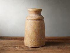 a vase sitting on top of a wooden table