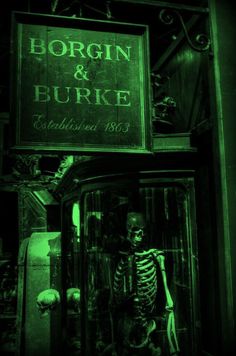 a skeleton is standing in the doorway of a building with a sign above it that says bordi and burge