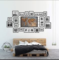 a bed with lots of pictures on the wall above it