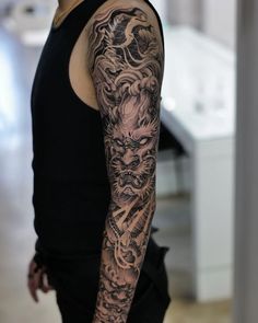 a man with a dragon tattoo on his arm