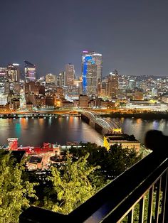 the city skyline is lit up at night