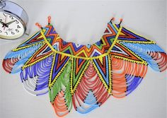 Unique African Maasai Handcrafted Beaded Necklace with an Elegant Look and Brilliant Finish.Color - Multi Color.Size - 13-13.5 inches.Fringe Length - 7 Inches / 18 cm.**GET FREE SHIPPING FOR ADDITIONAL ITEMS PURCHASED.Yes, Buy Multiple Items and pay shipping for 1 item only- The rest ships Free. (No Limits on the number of Multiple items). With a faster delivery time of 3 days via DHLExpress, Worldwide. Ordinary/Standard Shipping also available upon request. We Custom Make to Suit Your Taste and Multicolor Traditional Bib Necklace With Large Beads, Multicolor Beaded Chain Bib Necklace For Festival, Bohemian Multicolor Bib Necklace With Large Beads, Festival Multicolor Beaded Bib Necklace, Traditional Multicolor Beaded Necklaces, Multicolor Large Beads Bib Necklace For Festivals, Festival Multicolor Bib Necklace With Large Beads, Multicolor Bib Necklace With Dangling Beads For Festivals, Handmade Multicolor Bib Necklace For Festival