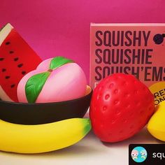 some fruit is sitting in a bowl next to a sign that says squishy soushie soufflems