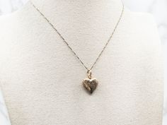 Declare your love with this charming yellow gold etched heart-shaped locket! It's the perfect way to share your secrets and wear your heart on your sleeve.This pendant does not come with the chain shown. Please feel free to contact us, we will help you find the perfect chain for your style and budget!Metal: 14K Yellow GoldMeasurements: 16 x 25 mm, with bailMarks: "14K ESEMCO" Stamped on the inside 14k Gold Heart Pendant Locket For Anniversary, Yellow Gold Heart Necklace With Vintage Charm, Heart-shaped 14k Yellow Gold Locket Necklace, Heart Shaped 14k Yellow Gold Locket Necklace, 14k Yellow Gold Heart Locket Necklace, Vintage Charm Heart-shaped Yellow Gold Jewelry, Yellow Gold Heart Jewelry With Vintage Charm, 14k Gold Heart-shaped Engraved Locket Necklace, 14k Gold Heart Locket Necklace For Wedding