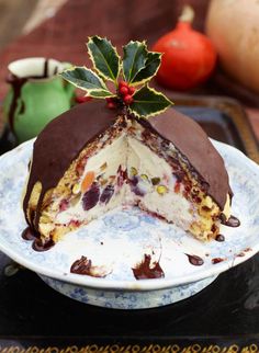 a piece of cake on a plate with chocolate and candy toppings around the edges