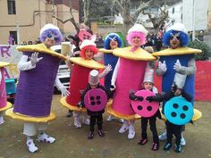 a group of people dressed in costumes and holding up large objects with ladybugs on them