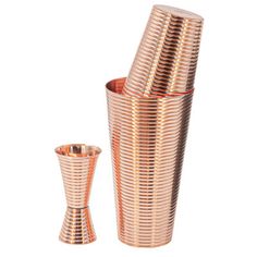 a set of three copper colored cups and a tall one are shown in the image