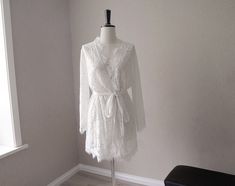 Very lovely robes, sheer lace fabric, will be perfect for wedding or honeymoon, or photoshoot. The lace fabric is very delicate, it looks pretty but fragile, iron/steam it with very low heat, handwash it and hang dry. Don't use high heat, or you'll burn the fabric. Size: Free size M can fit most, which would be good for hips measurements under 40 inches. if you need plus size, we can do that, please contact My height 5'4, 34 inches on me is mid thigh length Note: Please know each robe is handmad Long Lace Robe For Wedding Night, Delicate Lace Robe For Wedding Night, Sheer Lace Wedding Robe, Elegant Lace Honeymoon Dress, Long Sleeve Lace Wedding Robe, Sheer Long Sleeve Wedding Robe, Wedding Lace Long Sleeve Sleepwear, Long Sleeve Lace Wedding Sleepwear, Wedding Night Lace Sleepwear With Lace Sleeves