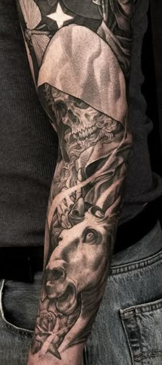 a man's arm with tattoos on it and an american flag in the background