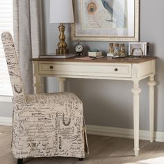 a desk with a chair and a painting on the wall