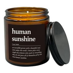 a candle with the label human sunshine on it