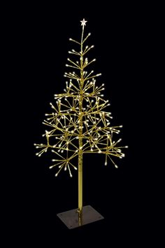 a lighted christmas tree on a stand with lights in the shape of a star, against a black background