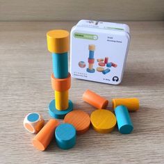 a wooden block set sitting on top of a table next to a tin canister