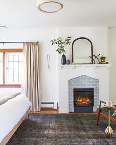 a room with a fireplace and a bed in it